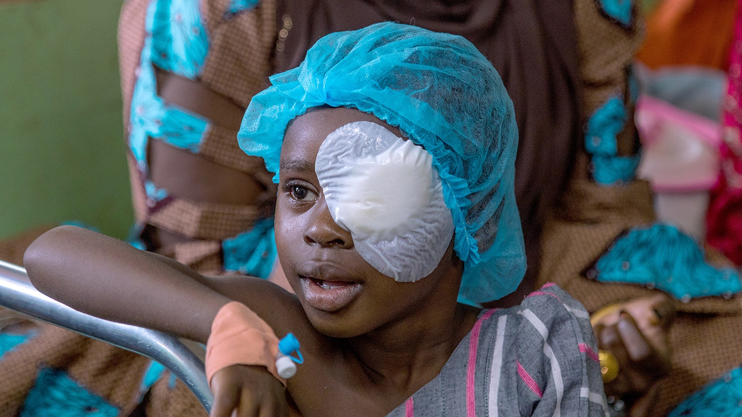 Khadijah wears a bandage over her left eye after receiving cataract surgery.