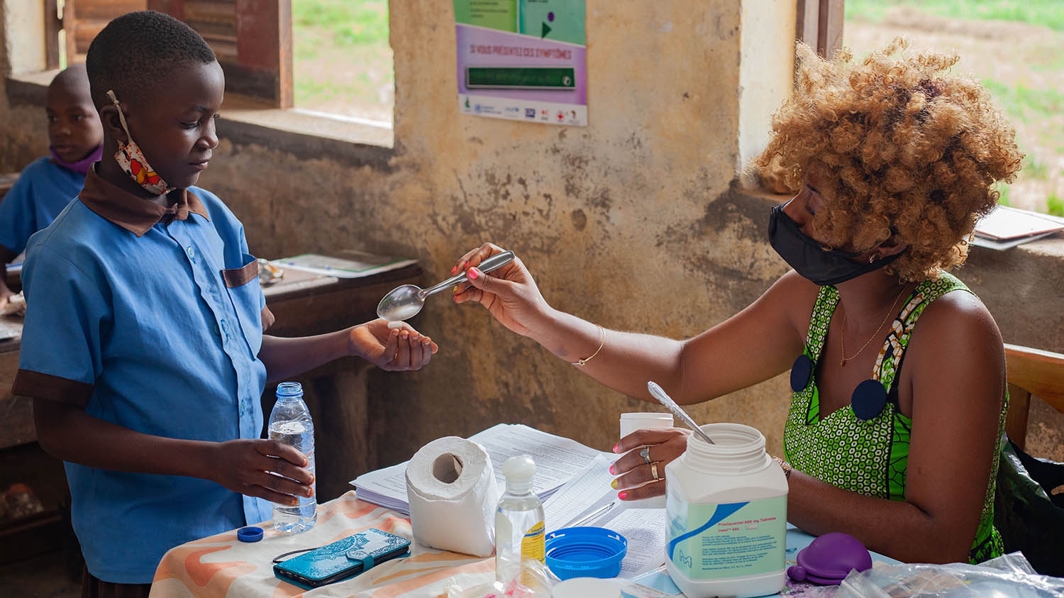 A child receives a deworming treatment at school in Cameroon.