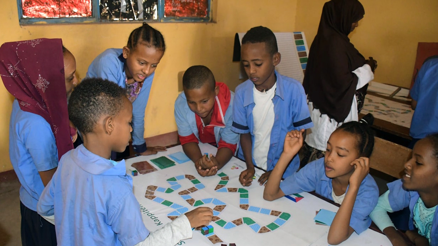Schoolchildren in Ethiopia play a game that teaches them about the importance of WASH to combat diseases.