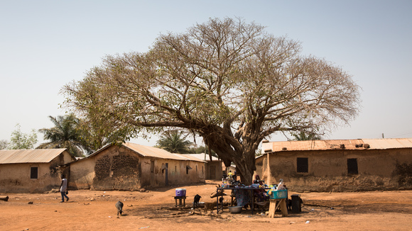 Woman sewing under a tree in Yendi, Ghana