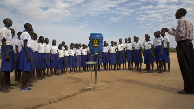 A group of children are taught how to improve sanitation