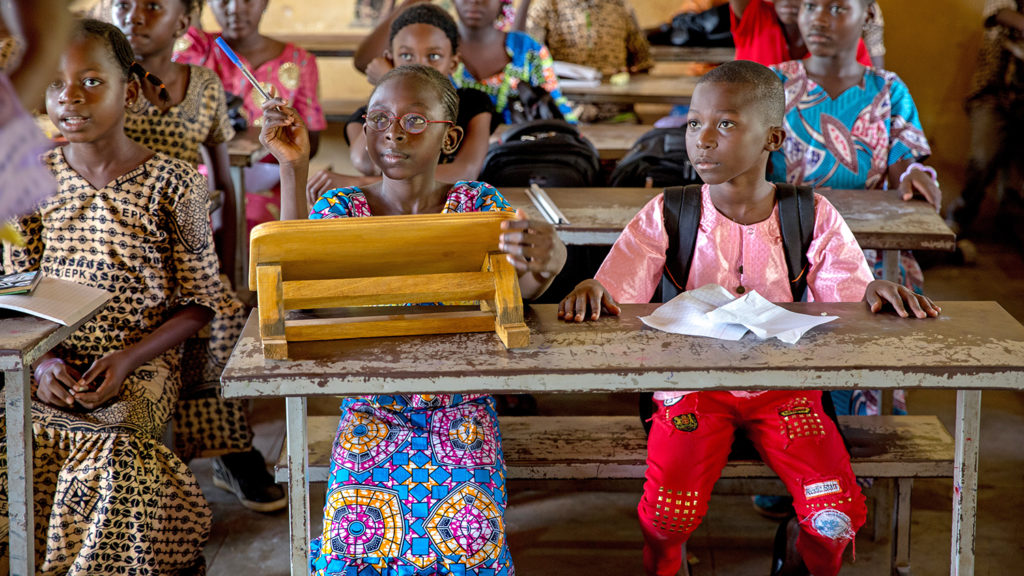 School children sit at desks at an inclusive school in Mali.
