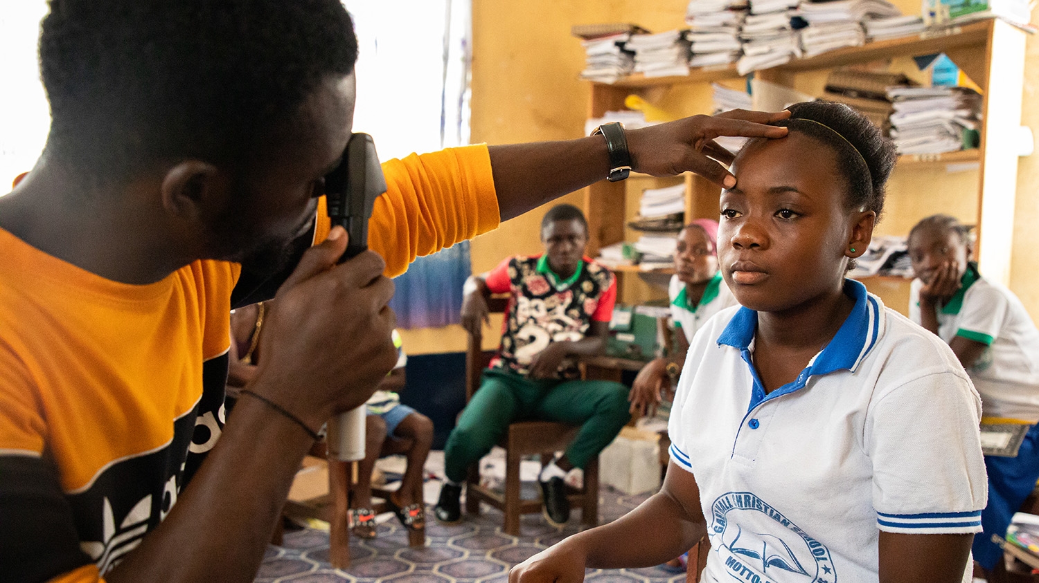 Teenager Faith gets her eyes tested at school in Liberia.