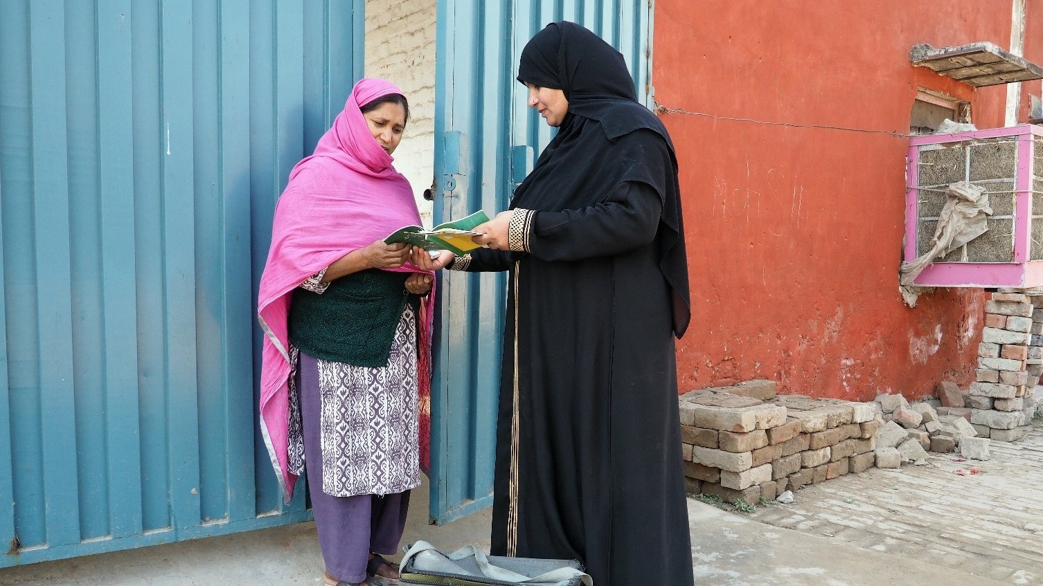 A Lady Health worker in pakistan handing out information.